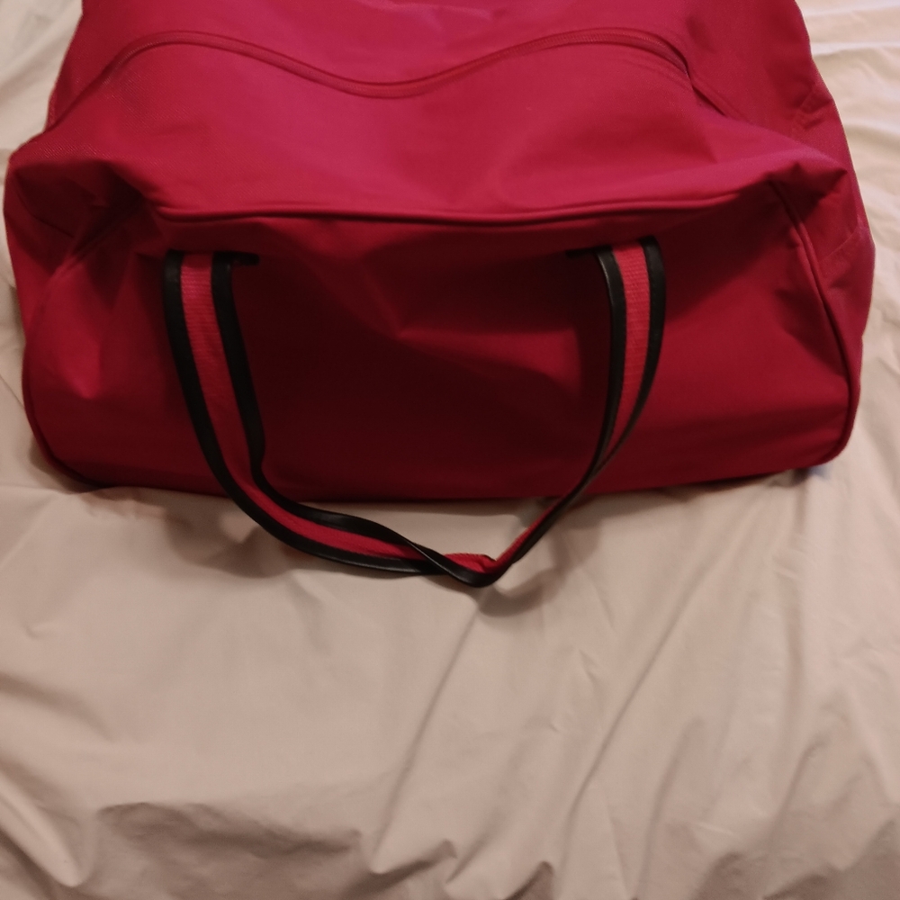 Red canvas rolling travel bag